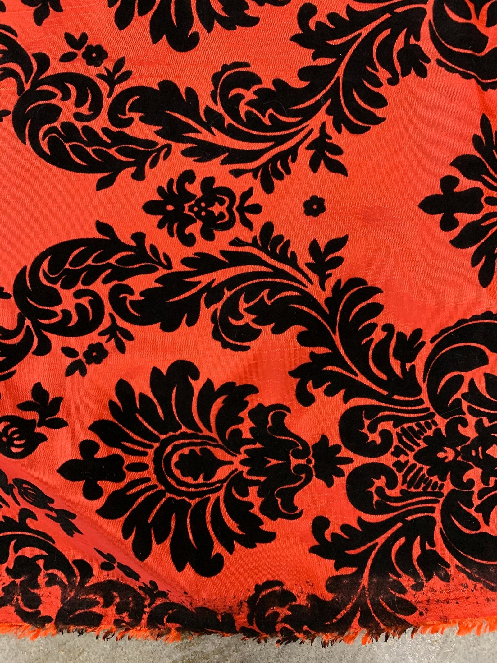 Amanda Red taffeta with raised black velvet-flocked damask pattern from New Fabrics Daily