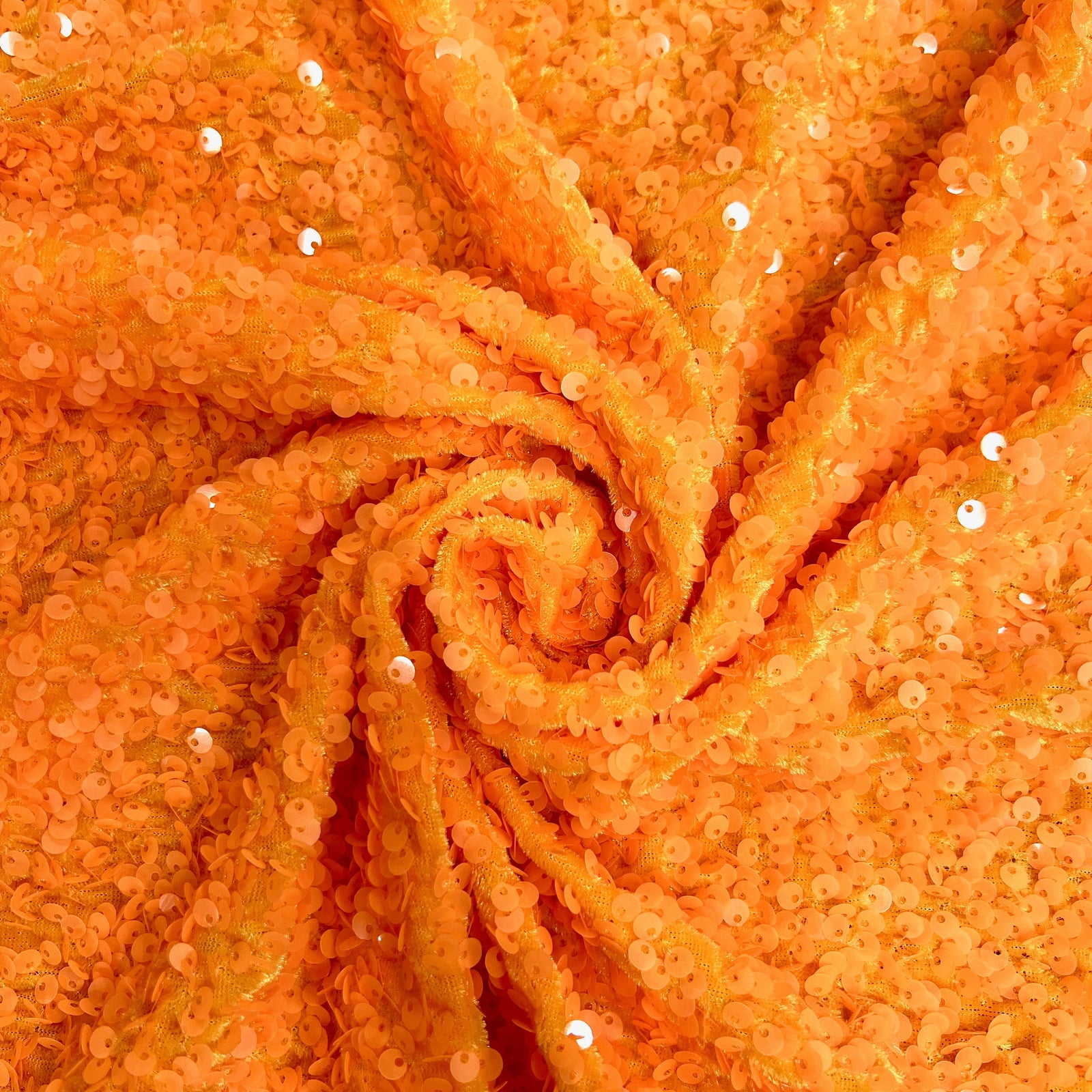 Stephanie Orange overlapping sequins on orange two-way stretch velvet from New Fabrics Daily
